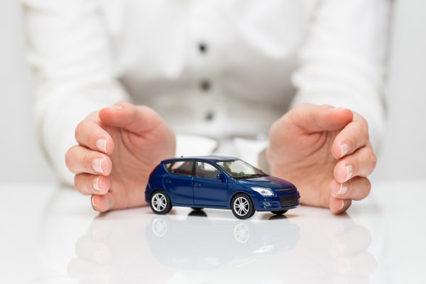 USAA extended car warranty service overview man in white holding blue toy car between hands white background